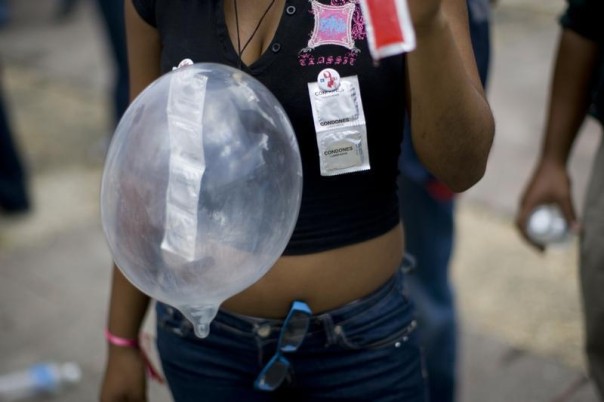 A woman with condoms attached to her clothes at a march to raise awareness of violence against women and HIV/AIDS, Santo Domingo April 25, 2009. REUTERS/Eduardo Munoz