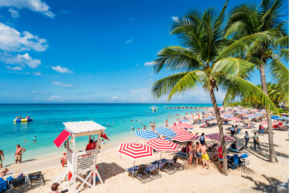 People enjoy Doctor's Cave Beach in Montego Bay Jamaica on a sunny day.