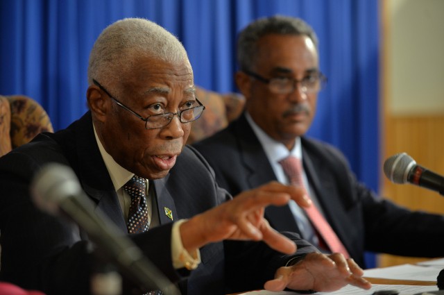 Minister of Foreign Affairs and Foreign Trade, Senator the Hon. A.J. Nicholson (left), fields questions from journalists during a Jamaica House media briefing April 16. Also pictured is Permanent Secretary in the Foreign Affairs Ministry, Ambassador