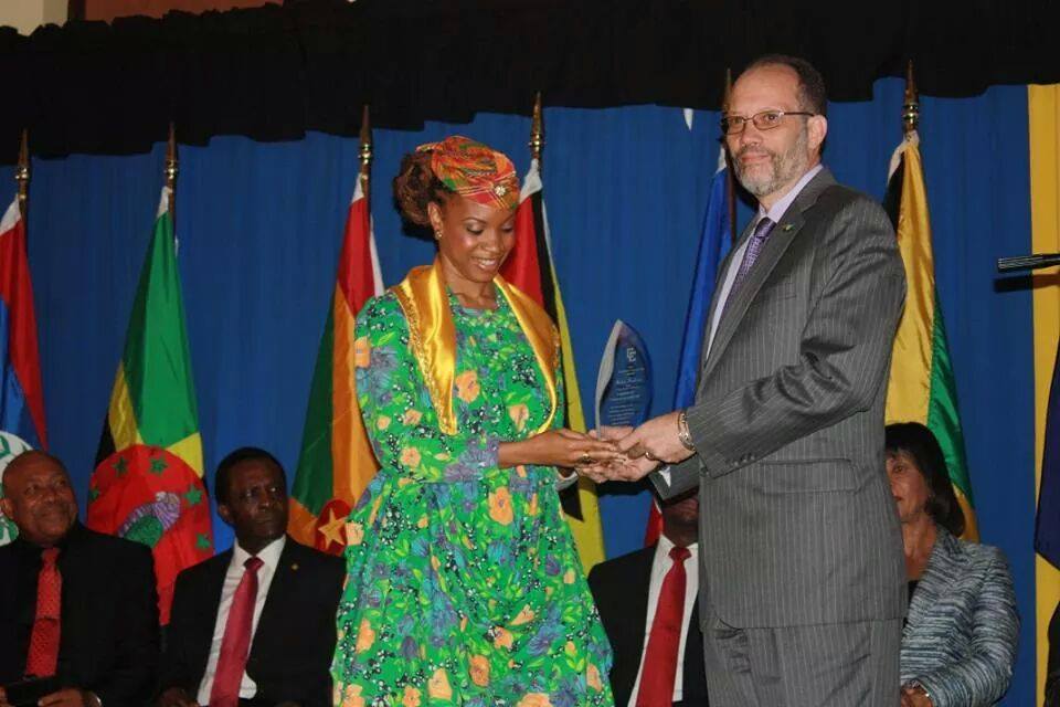 Michele Henderson receives award for the winning CARICOM Song composition from CARICOM Secretary-General Ambassador Irwin LaRocque