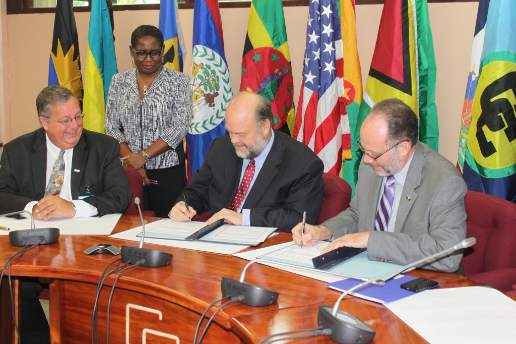 Signing the three agreements: (r-l) CARICOM Secretary-General Ambassador Irwin LaRocque, US Ambassador to CARICOM Perry Holloway, and Mission Director, USAID, Eastern and Southern Caribbean, Christopher Cushing
