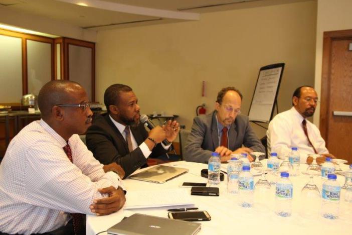 Mr. Ronald Jackson, Executive Director of CDEMA, second from left makes a point during a meeting. Next to him is Executive Director of CARPHA, Dr. James Hospedales