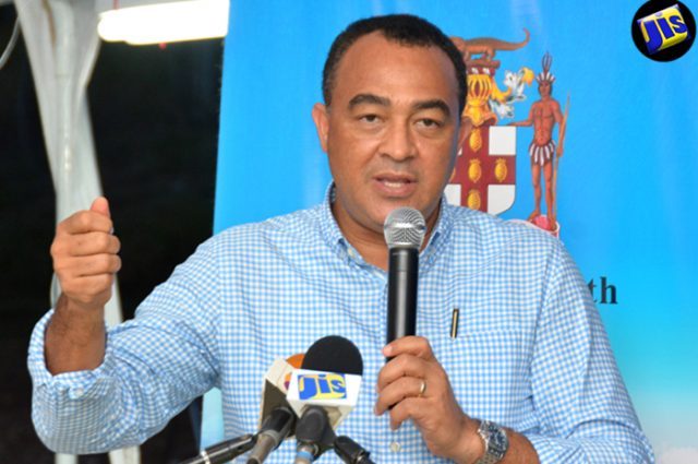 Minister of Health, Dr. the Hon. Christopher Tufton addresses Town Hall Meeting at the Sandy Bank Primary School in Treasure Beach, St Elizabeth, on July 21. (Photo via Jamaica Information Service)