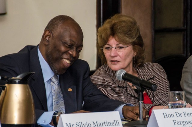 Photo: JIS Photographer Minister of Health, Hon. Dr. Fenton Ferguson (left), in discussions with Global Fund Board Member and Latin America and the Caribbean Representative, Dr. Mirta Roses Periago, during Fund&rsquo;s regional meeting held at the Ja