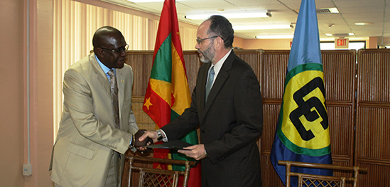 Newly appointed Grenadian Ambassador His Excellency Patrick Antoine hands over his credentials to Secretary General of the Caribbean Community Ambassador Irwin LaRocque in a ceremony at the CARICOM Secretariat in Georgetown Guyana on Tuesday.