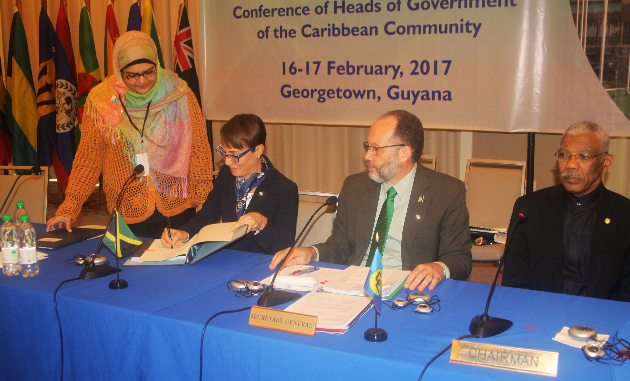 Senator The Hon. Kamina Johnson-Smith, Minister of Foreign Affairs and Foreign Trade of Jamaica, signing the Amendment to the CDF Agreement, while CARICOM Secretary-General Ambassador Irwin LaRocque looks on