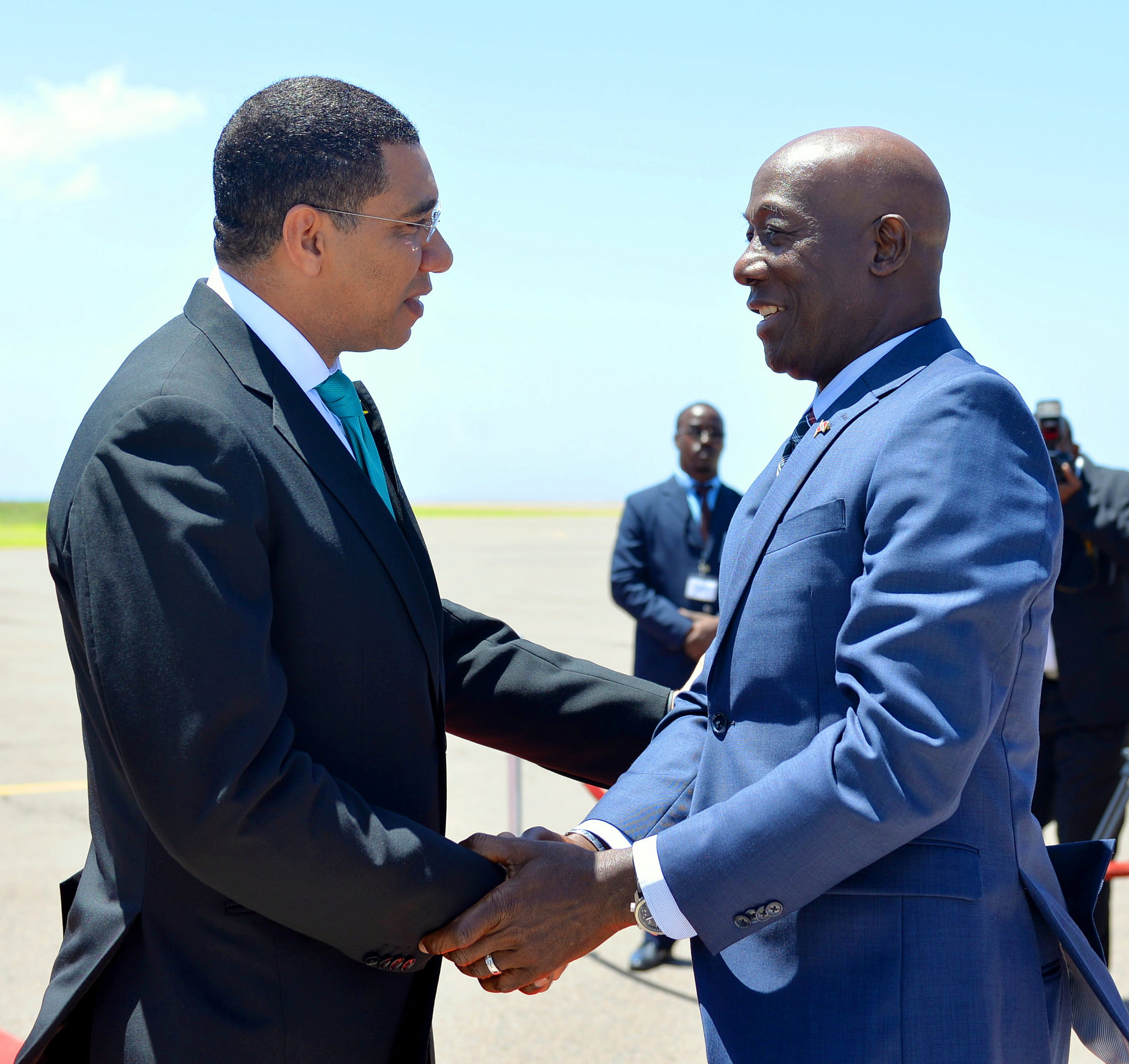 Prime Minister the Most Hon. Andrew Holness (left), greets Dr. the Hon. Keith Rowley, Prime Minister of Trinidad and Tobago, on his arrival at the Norman Manley International Airport today (July 17), for the start of an Official Visit to the island.