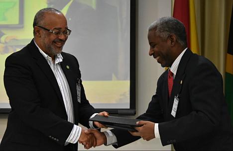 Dr Didacus Jules (L), Director General of the OECS Commission, with Nigel Cassimire, acting Secretary General of the Caribbean Telecommunications Union, at the signing of a memorandum of understanding between the OECS and the CTU in Tortola, BVI, on