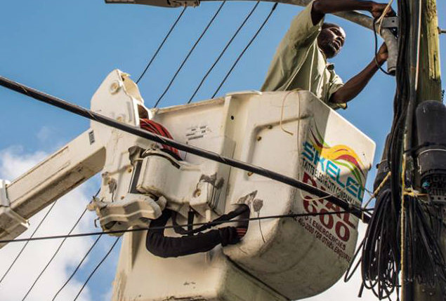 SKELEC serviceman installing new LED lights in Downtown Basseterre