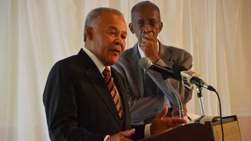 Former Barbadian Prime Minister, Owen Arthur (left) giving the keynote address on Thursday, July 16, at the Partnership for Jamaica retreat, chaired by Prime Minister, the Most Hon. Portia Simpson Miller, at the Terra Nova Hotel. Listening closely is