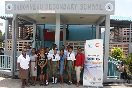 Members of the CARICOM team Ms. Beverly Reynolds (third left in front) and Dr. Carolyn Gentle-Genitty (second left at the back) pose for a photograph with Principal of the Babonneau Secondary School Terrence Fernelon (first left at the back) as well