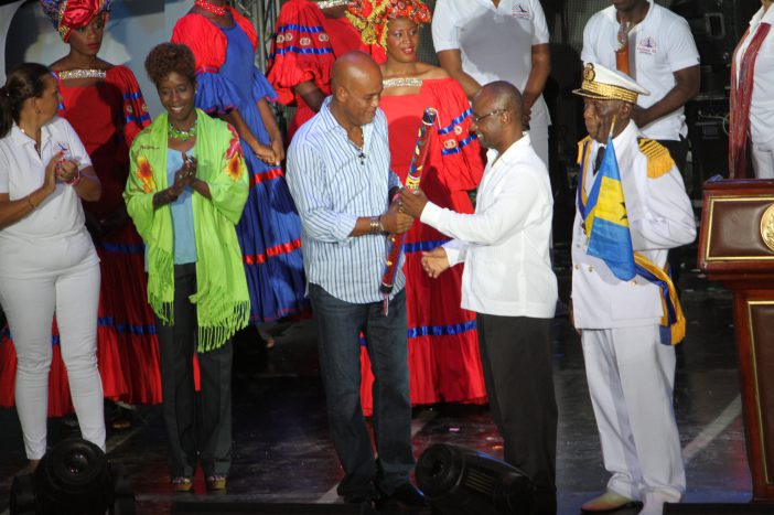 Haiti&rsquo;s President H.E. Michel Martelly passes the CARIFESTA Baton to Barbados Minister of Culture Hon. Stephen Lashley at CARIFESTA XII closing ceremony in August 2015 (CARICOM Secretariat file photo)