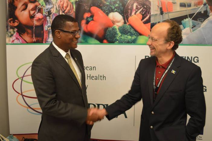 Premier of Turks and Caicos Islands, Dr. Rufus Ewing and CARPHA Executive Director, Dr. James Hospedales greet each other at the Meeting (Photo via CARPHA )