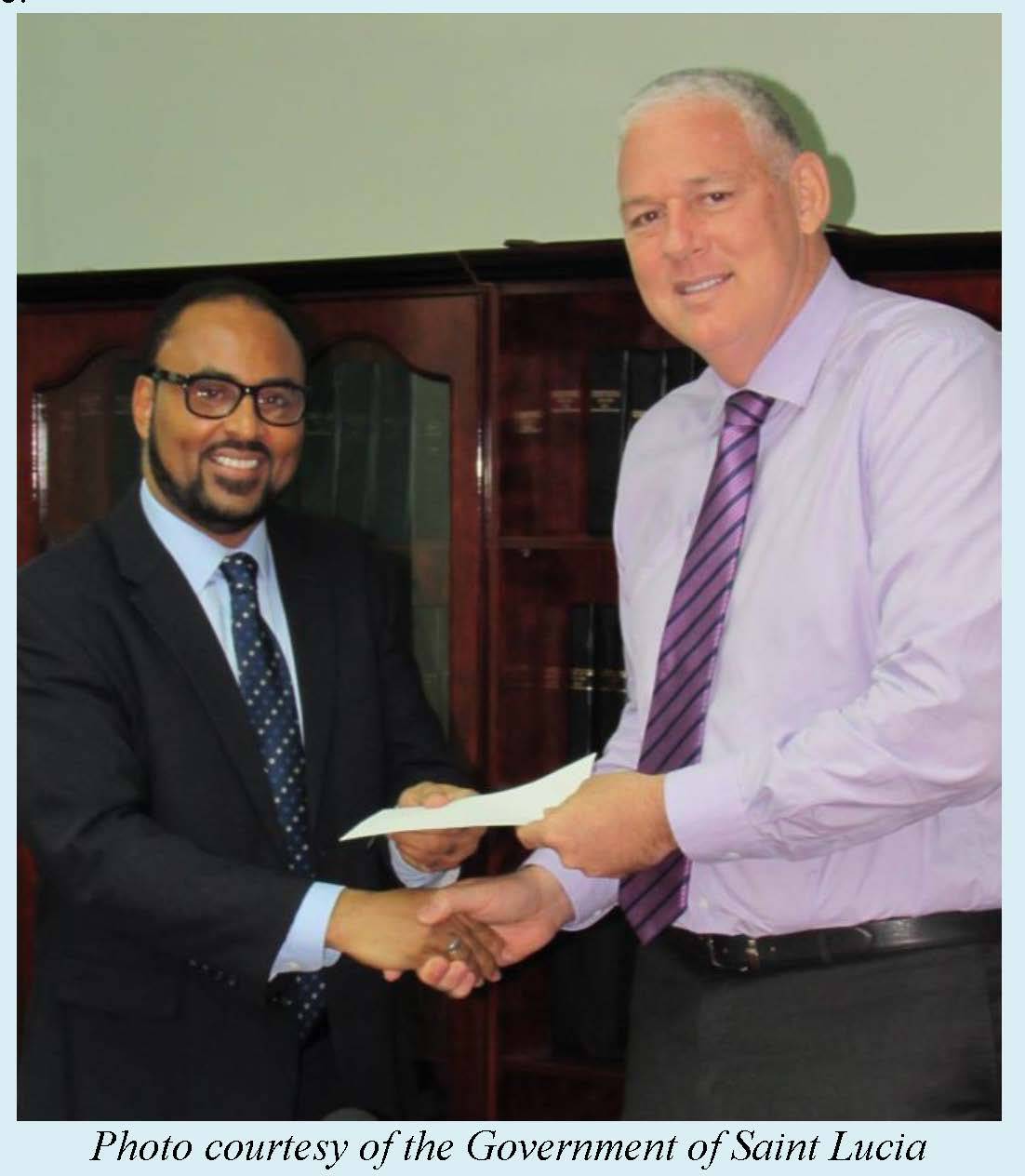 Saint Lucia&rsquo;s Prime Minister Hon. Allen Chastanet receives a cheque from CCRIF CEO Mr. Isaac Anthony
