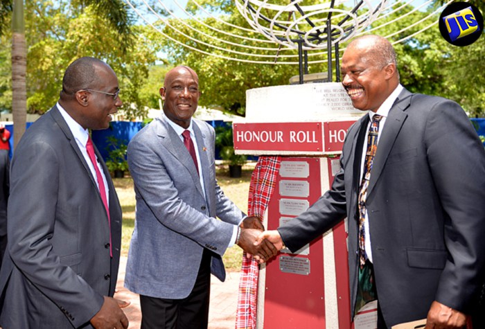 Prime Minister of the Republic of Trinidad and Tobago, Dr. the Hon. Keith Rowley (centre) is being congratulated by Vice Chancellor, University of the West Indies (UWI), Professor Sir Hilary Beckles (right) following Dr. Rowley&rsquo;s induction in t