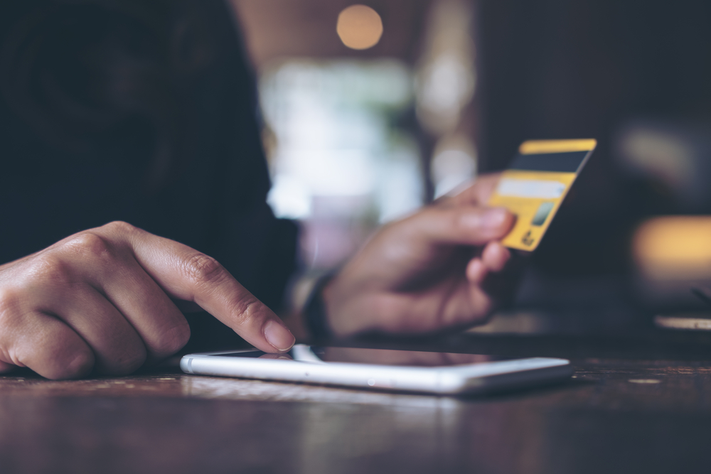 Closeup,Image,Of,A,Woman's,Hand,Holding,Credit,Card,And