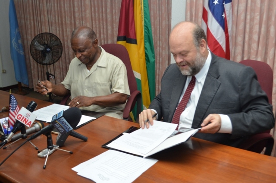 Minister of Foreign Affairs and Vice President Carl Greenidge and US Ambassador Perry Holloway, affixing their signatures to the Caribbean Basin Security Initiative&rsquo;s (CBSI&rsquo;s) &ldquo;Letter of Amendment Three Point Two,&rdquo; in the Main