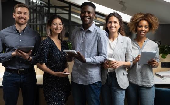 Portrait,Of,Happy,Successful,Multiracial,Business,Team,Standing,With,Digital
