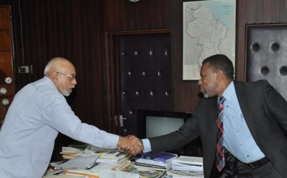 President Donald Ramotar greets Ronald Jackson, Executive Director, Caribbean Disaster Emergency Management Agency (CDEMA) (photo via GINA)