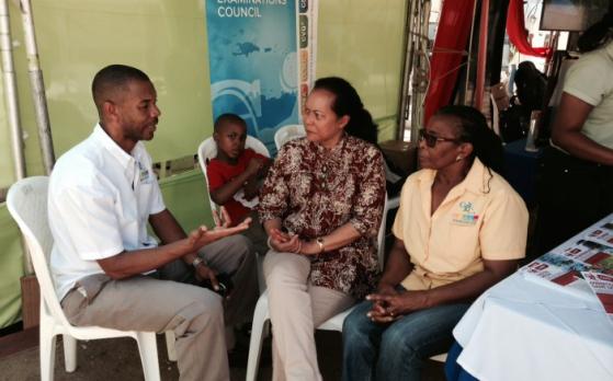 CXC Assistant Registrar Public Information and Customer Service, Mr. Cleveland Sam, elaborates on the new CAPE syllabuses to Deputy Progamme Manager, Culture at the CARICOM Secretariat Ms. Riane DeHaas Bledeog and Dr. Annette Piper, CXC Assistant Reg