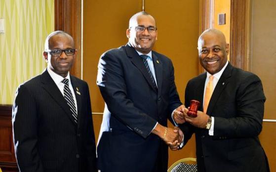 New CTO Chairman Obie Wilchcombe of the Bahamas (right) receives the gavel from his predecessor Richard Sealy of Barbados. Also in photograph, CTO secretary general Hugh Riley (Right) (Photo via CTO)