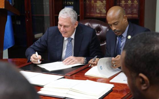 Saint Lucia Prime Minister, the Hon. Allen Chastanet and CDF Chief Executive Officer, Mr. Rodinald Soomer sign the agreement